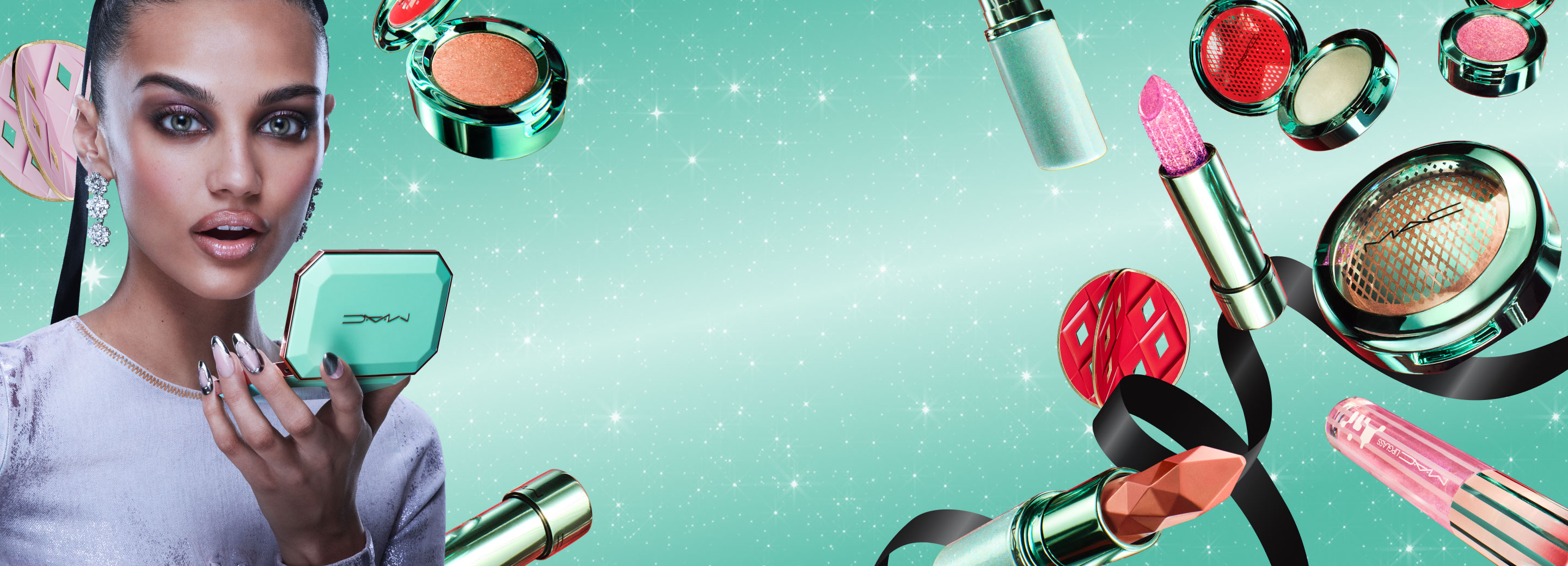 MAC Holiday gifts on teal background with model 